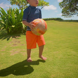 Little boy playing in UV Skinz's Kid's short sleeve swim shirt