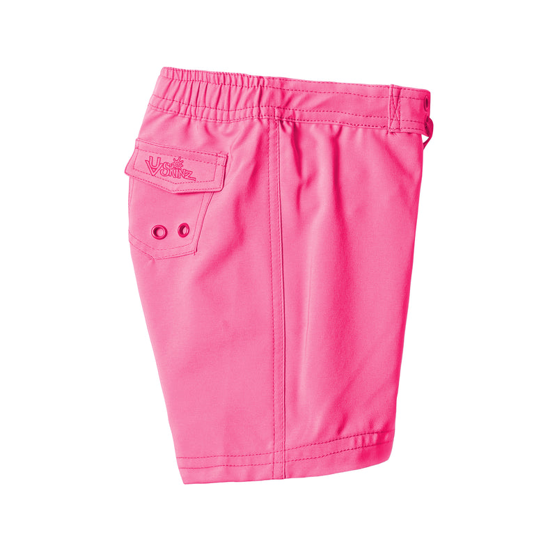 side view of the girl's board shorts in hot pink|hot-pink