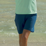 Woman Stretching in the Sun in Her Favorite UV Skinz's Women's Board Shorts