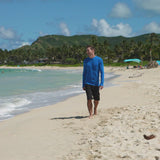Man walking on the beach in UV Skinz's men's coastal board shorts
