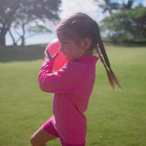 Little girl playing in UV Skinz's girl's swim shorts