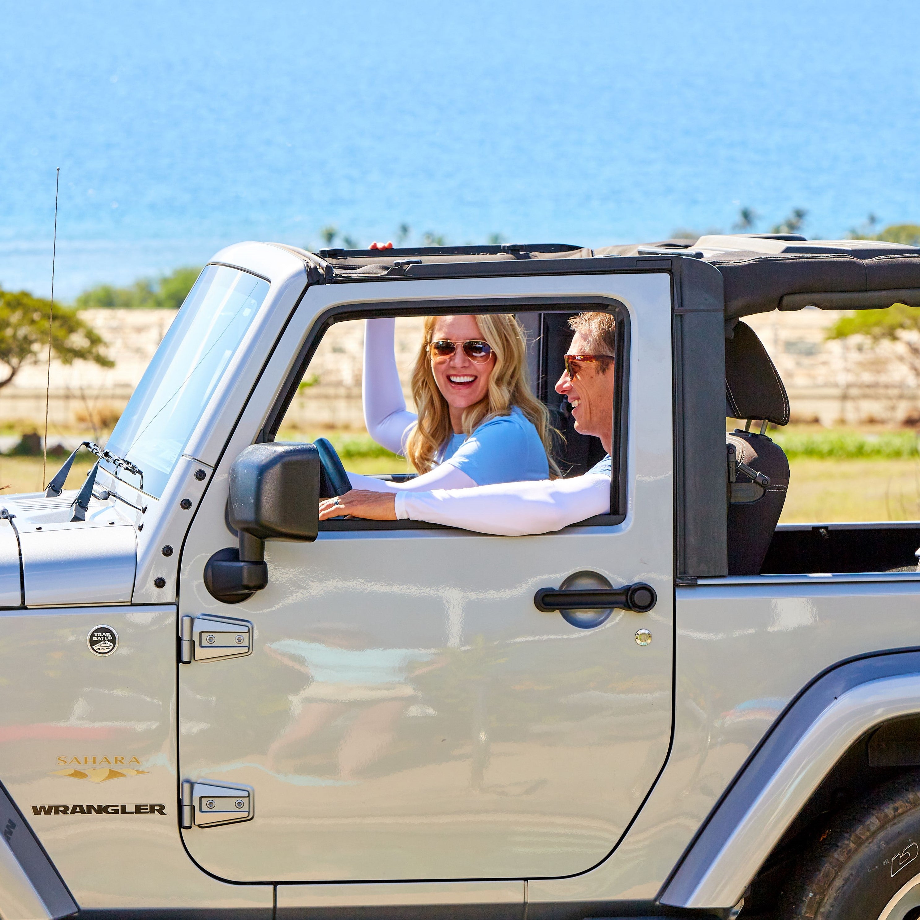 People driving in bamboo sun sleeves|sand