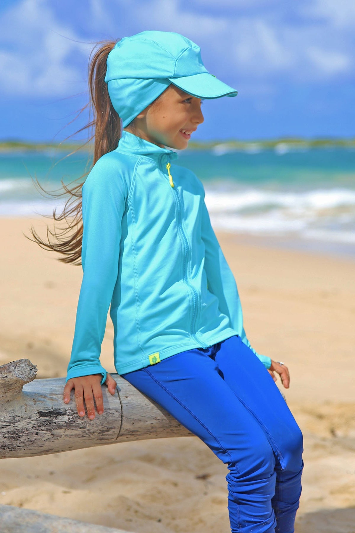 Little girl in UV Skinz's kid's active fleece hat in scuba blue|scuba-blue