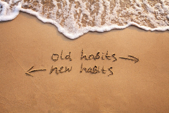 old habits and new habits written in sand