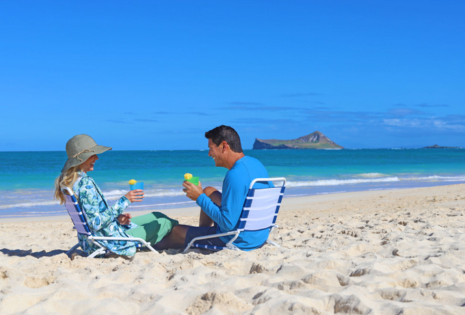 husband and wife on the beach in UPF swimwear