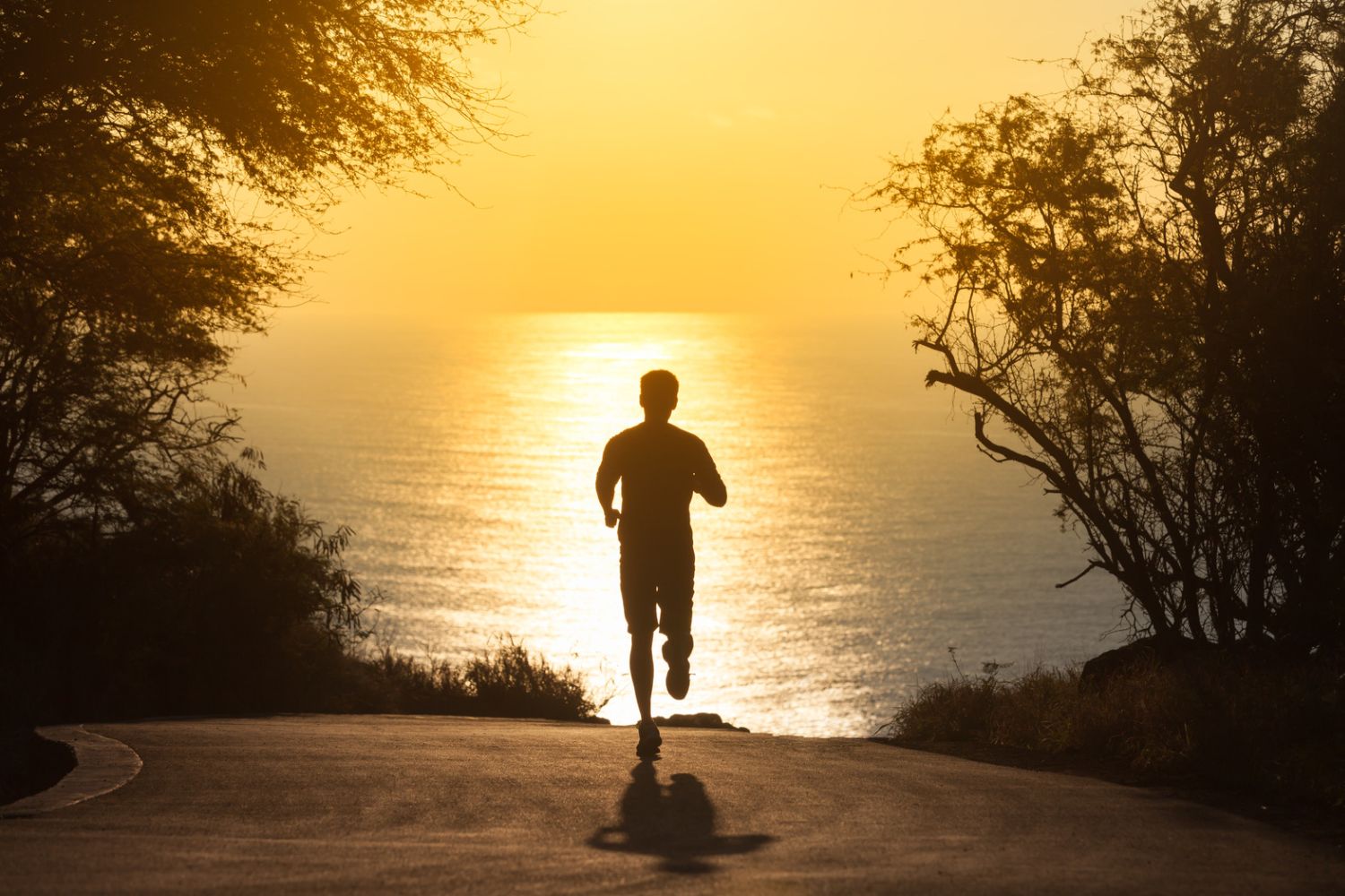 Man running in UPF 50+ clothing towards the ocean