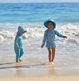 Babies in their baby UPF clothing at the beach