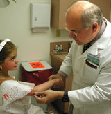 Dermatologist performing a skin check on a child