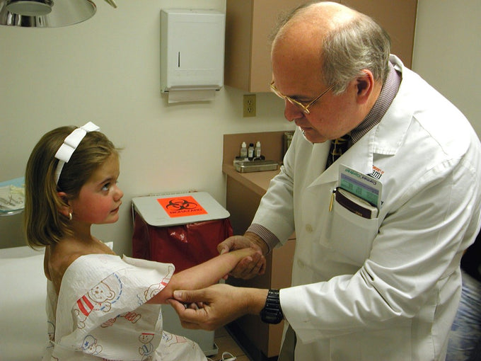Dermatologist performing a skin check on a child