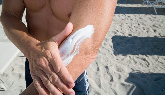Man applying sunscreen