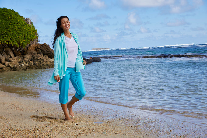 woman in a UV Skinz sun wrap on the beach