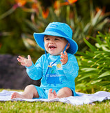 Baby in UV Skinz's sun-protective clothing