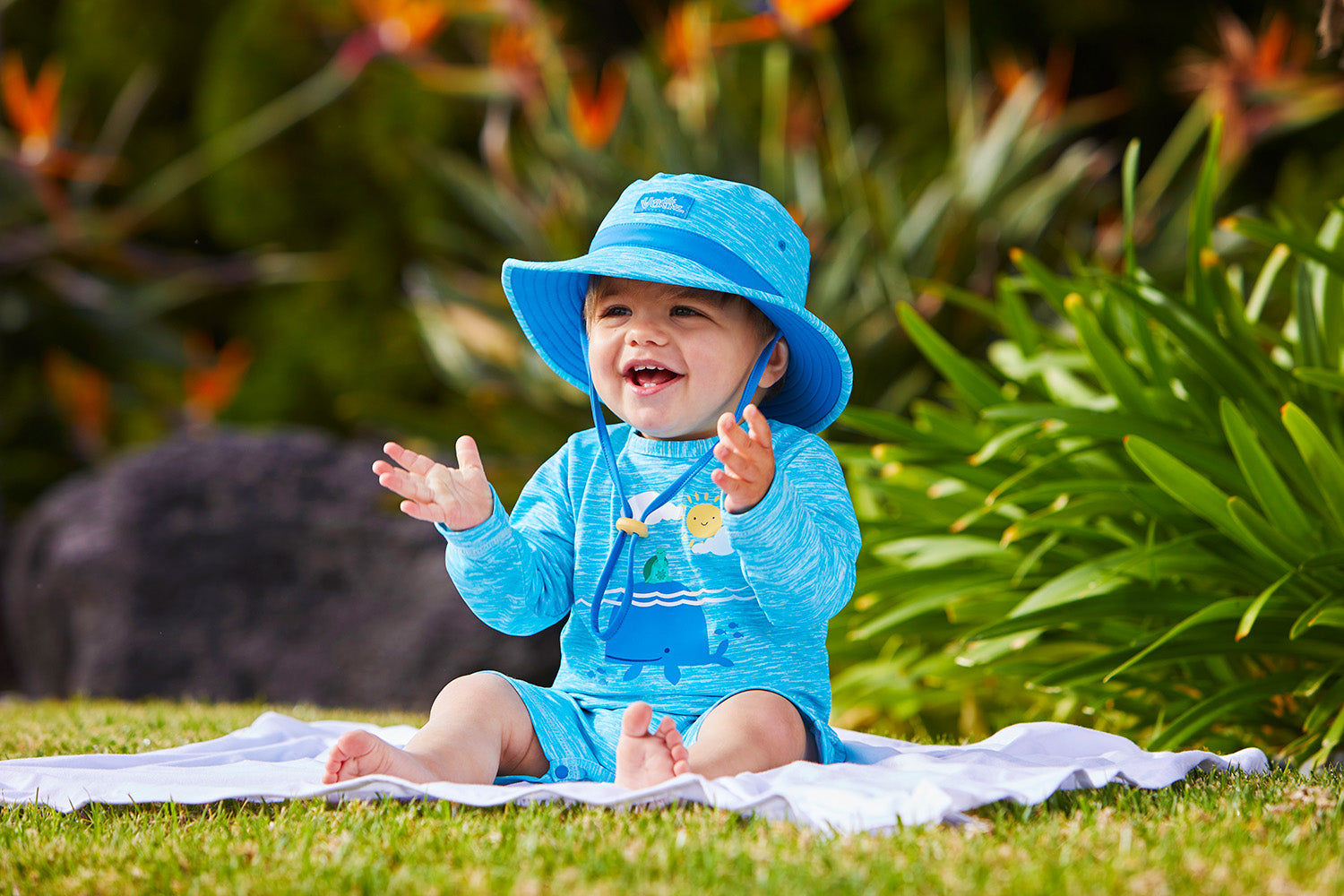 Baby in UV Skinz's sun-protective clothing