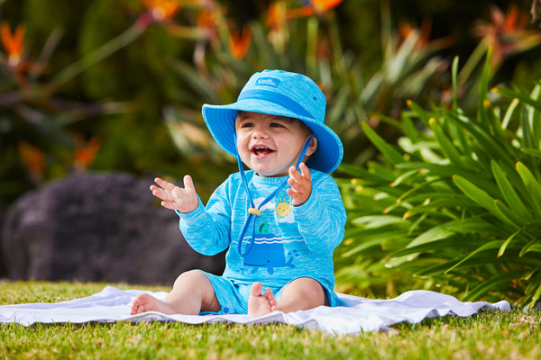 Baby in UV Skinz's sun-protective clothing
