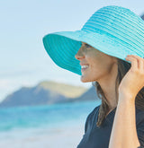 woman on vacation wearing a foldable UPF sun hat
