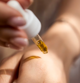 woman putting moisturizer on her skin for winter