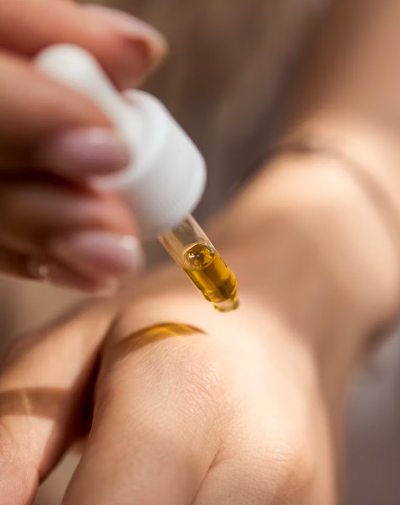 woman putting moisturizer on her skin for winter