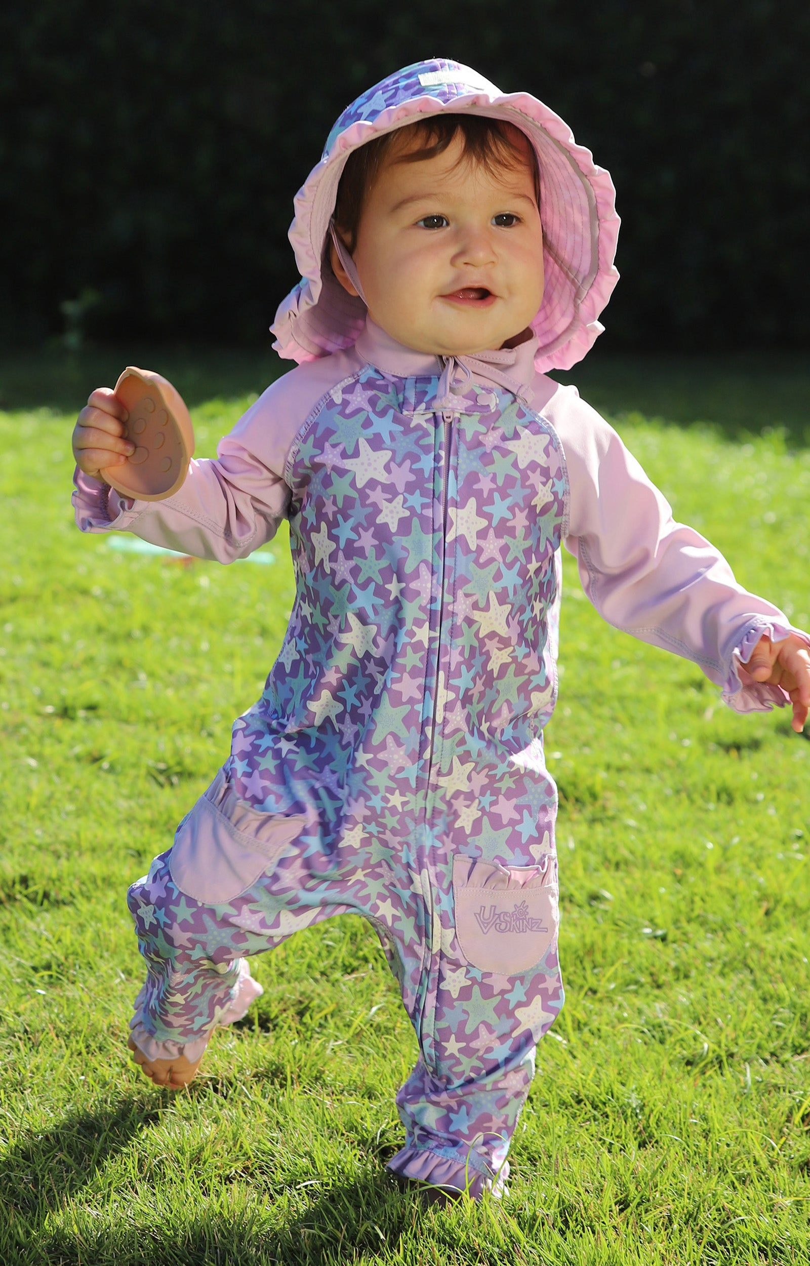 baby girl running in grass in sun & swim suit in lotus starfish|lotus-starfish