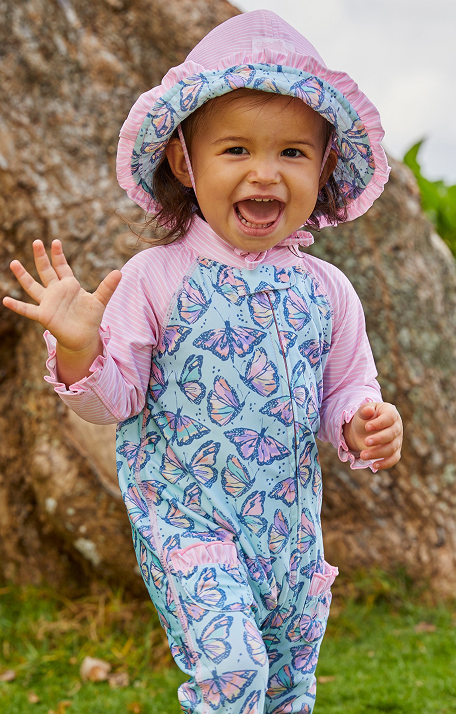 Little baby girl in UV Skinz's baby girls long-sleeve swimsuit in sweet butterflies|sweet-butterflies