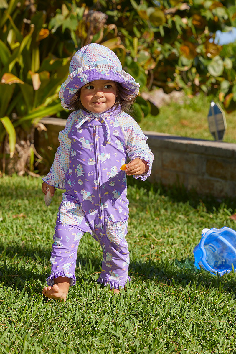 baby girl in UV Skinz's baby girls long-sleeve swimsuit in soaring unicorns|soaring-unicorns