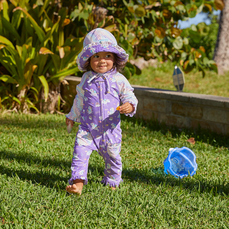 baby girl in UV Skinz's baby girls long-sleeve swimsuit in soaring unicorns|soaring-unicorns