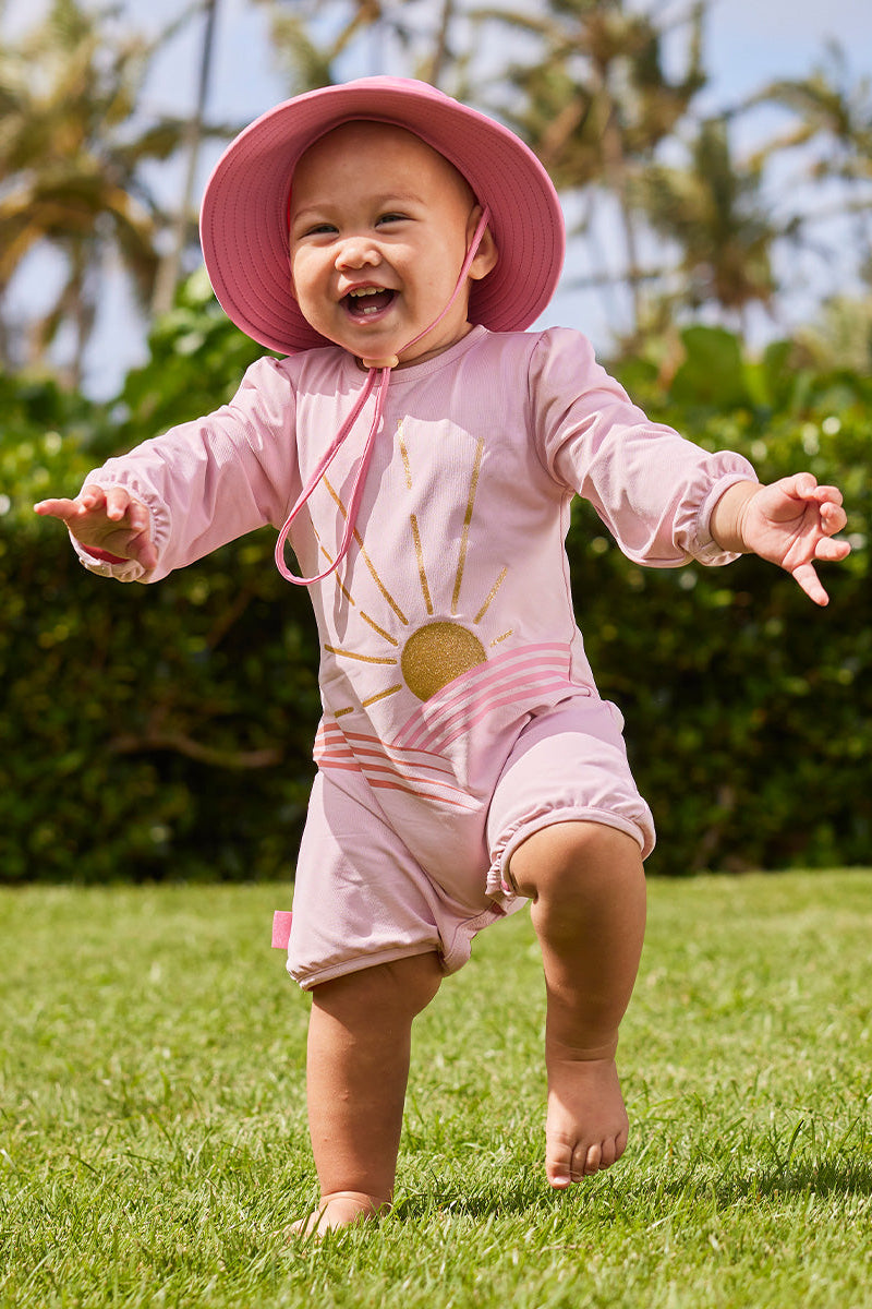 baby girl running in uv sunzie|glitter-sunshine