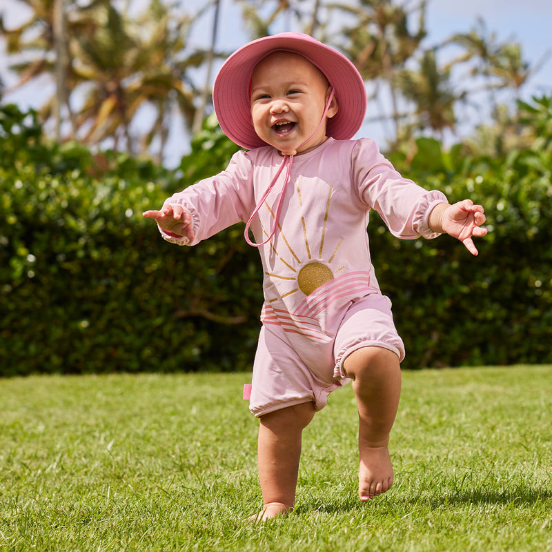 baby girl running in uv sunzie|glitter-sunshine