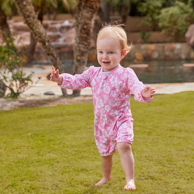 Little baby girl in UV Skinz's UPF 50+ one-piece swimsuit|pink-hibiscus-gingham