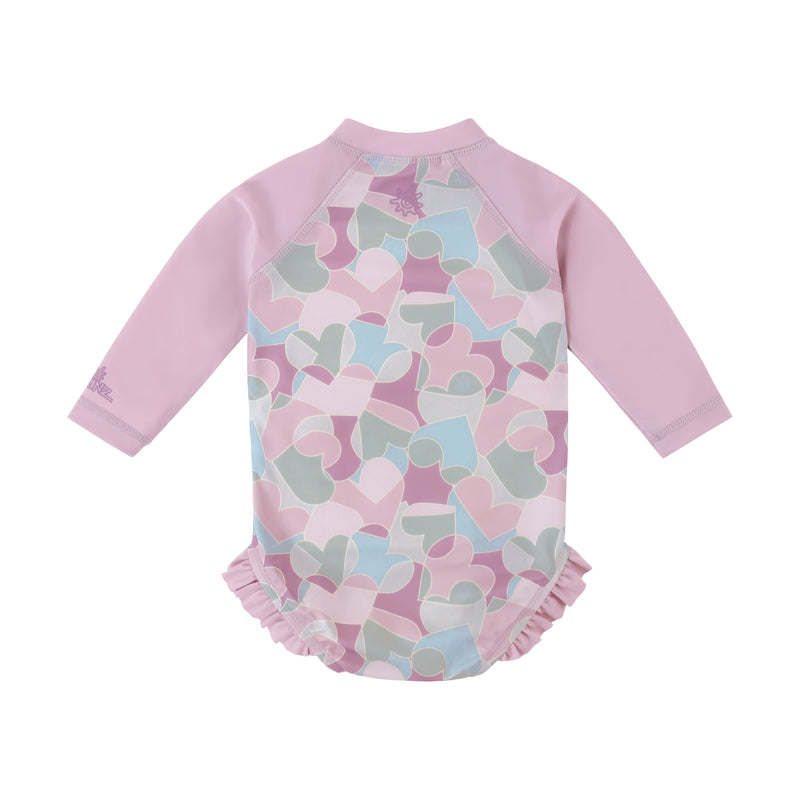 back view of baby girl long sleeve ruffle legged swim suit in puzzle hearts|puzzle-hearts