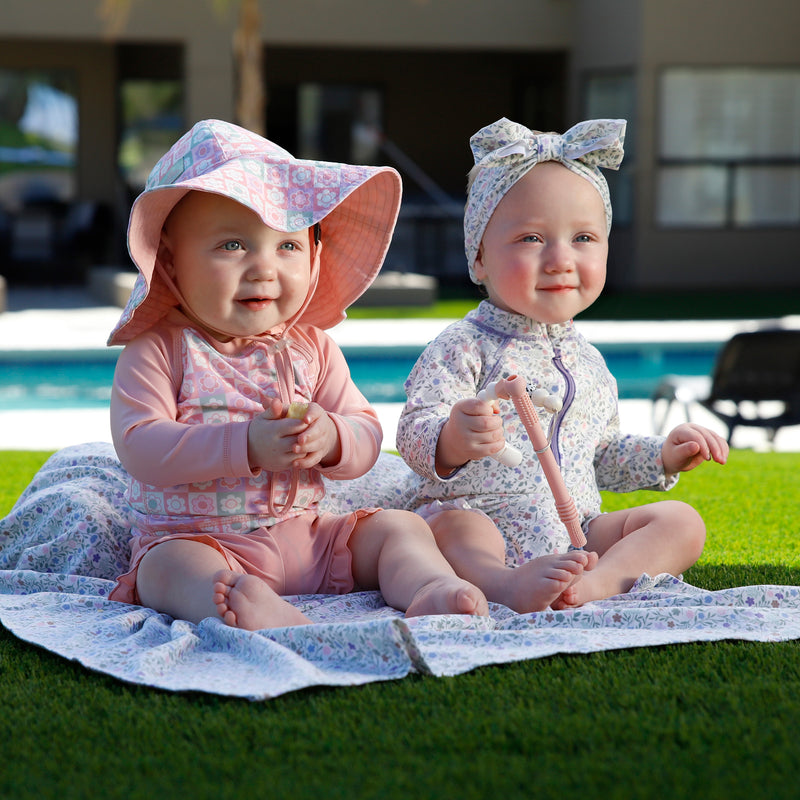 baby girl in long sleeve ruffled swim romper|sonora-meadows