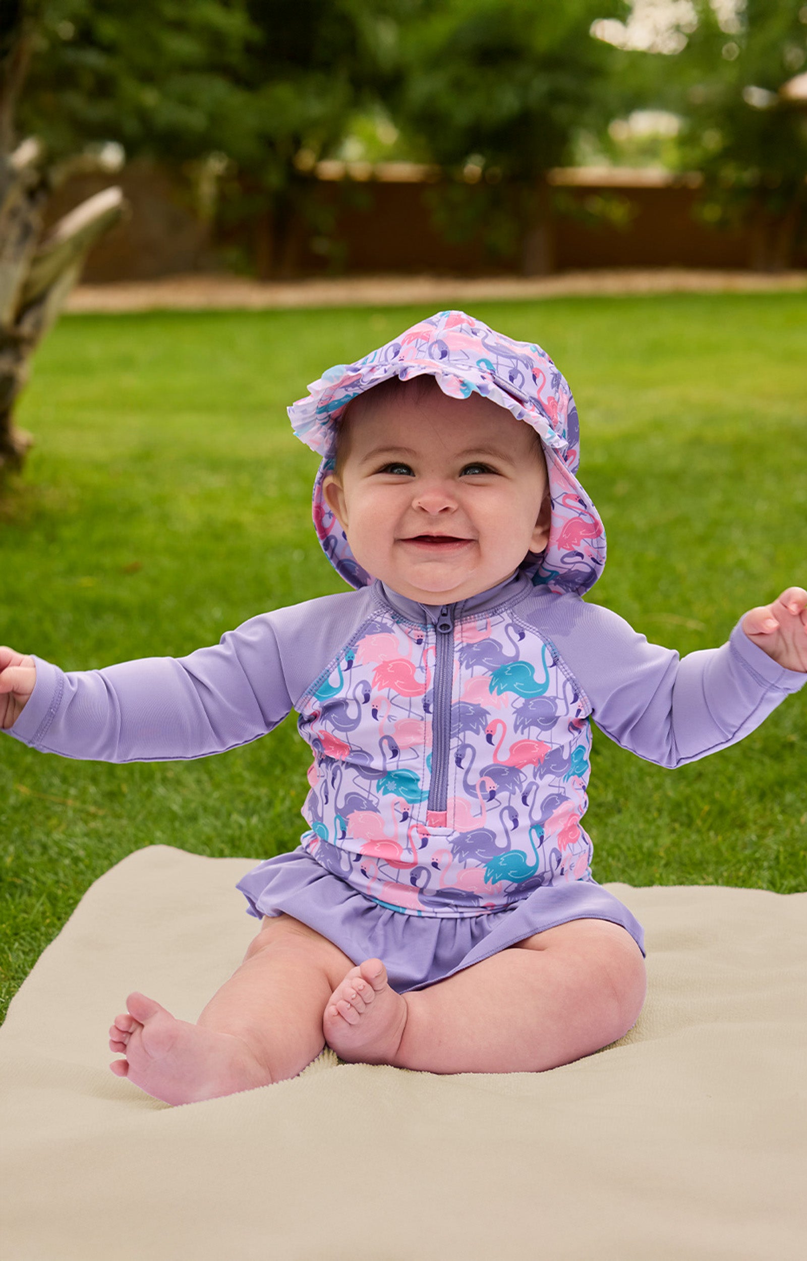 baby girl sitting in long sleeve ruffled swim suit|fancy-flamingos