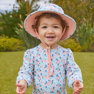 Baby girl in UV Skinz's baby girl's swim hat in meadow bloom|meadow-bloom