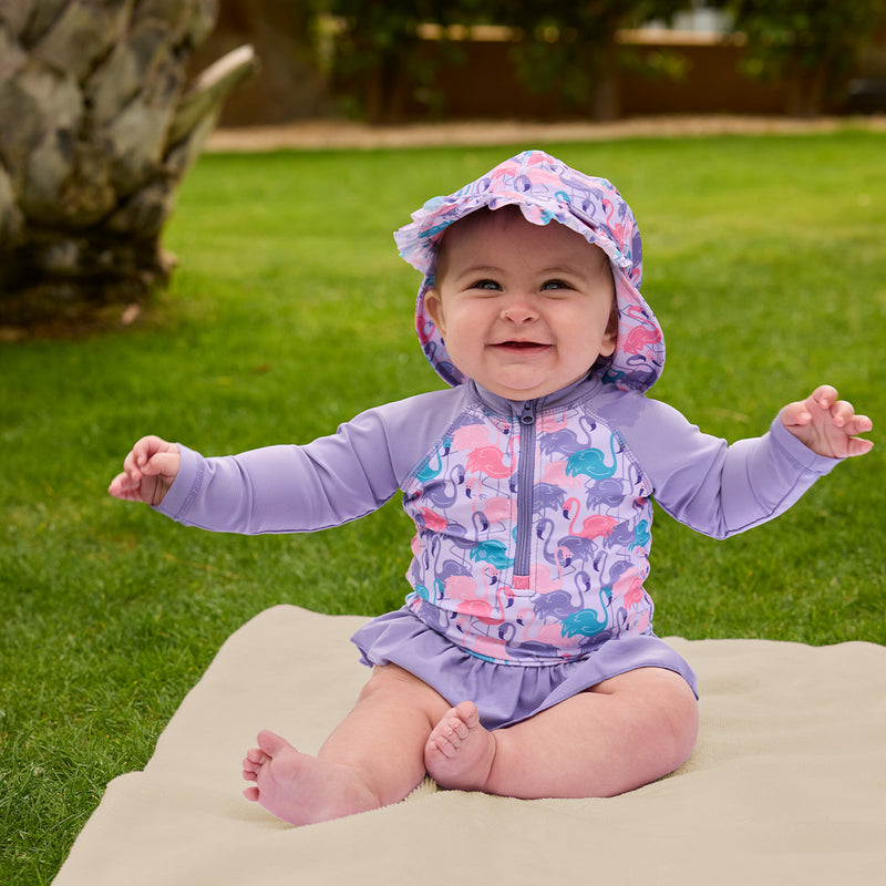 baby girl sitting in long sleeve ruffled swim suit|fancy-flamingos