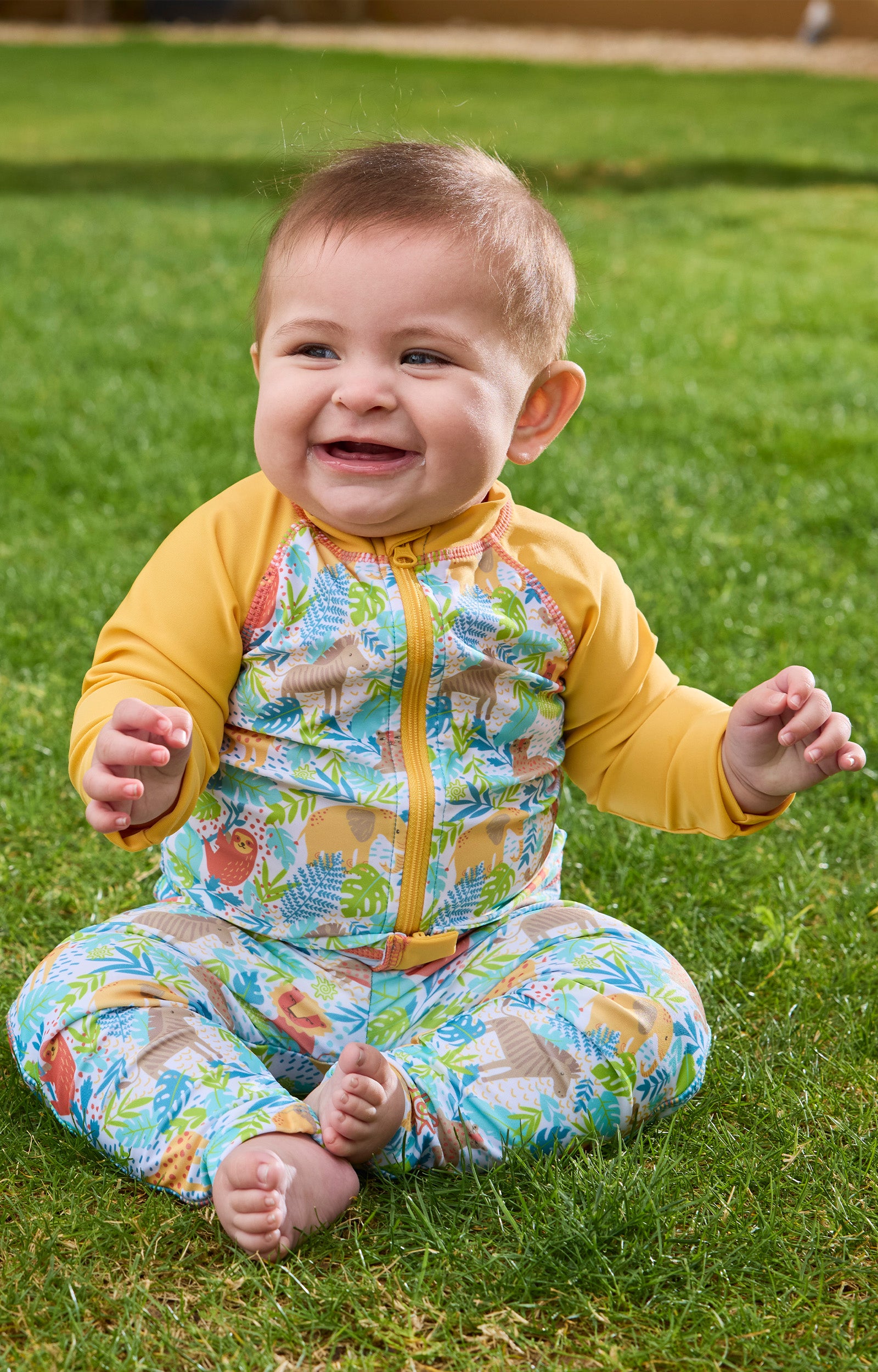 baby boy playing in grass in swim leggings|jungle-friends