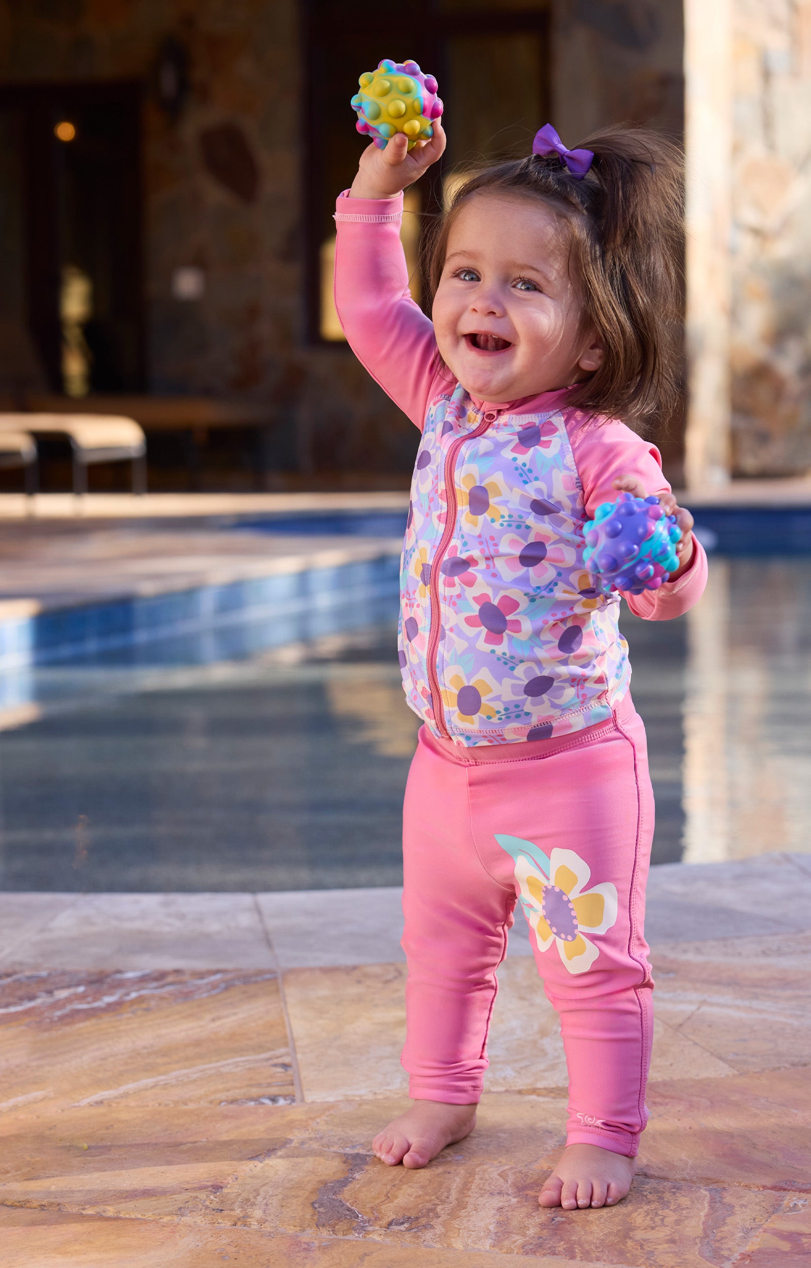 baby girl playing by pool in swim leggingz|wild-blossom