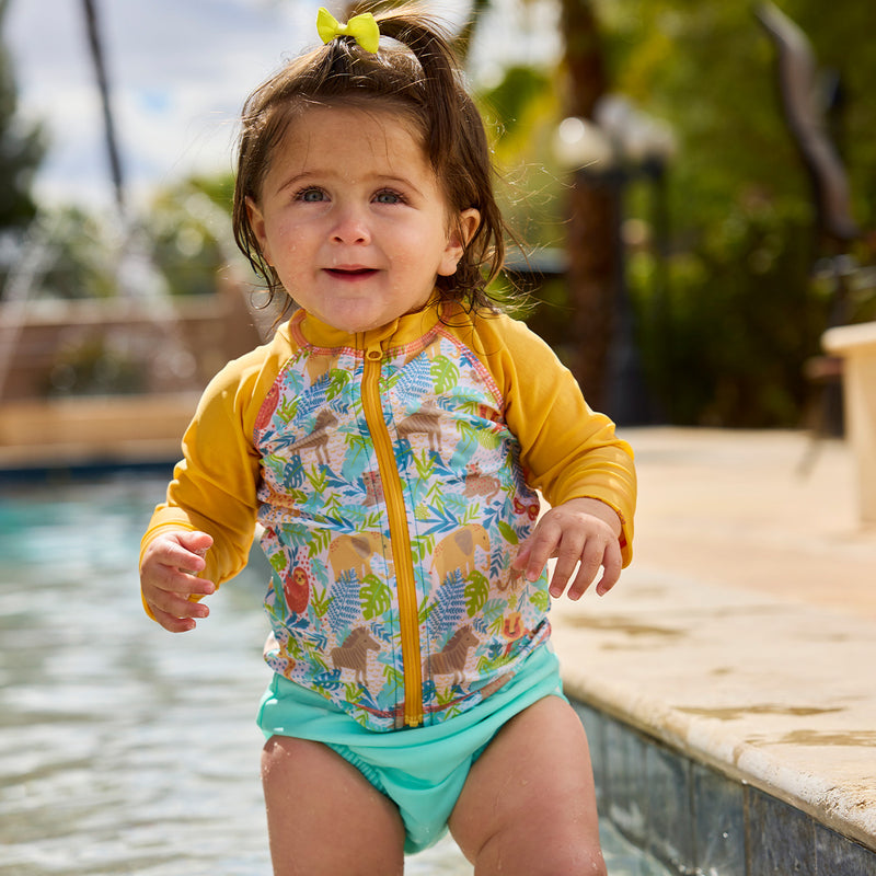 baby girl in pool in adjustable swim diaper in aruba|jungle-friends