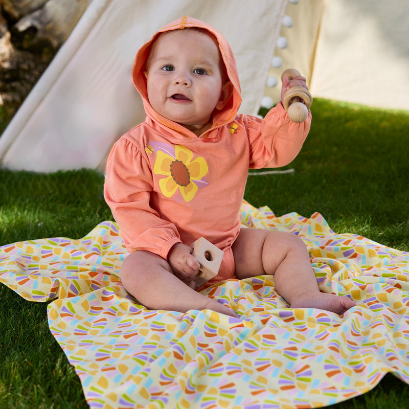 baby girl playing on my first sun blanket|radiant-rays