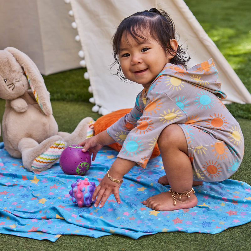 baby girl playing on my first sun blanket|scribble-stars