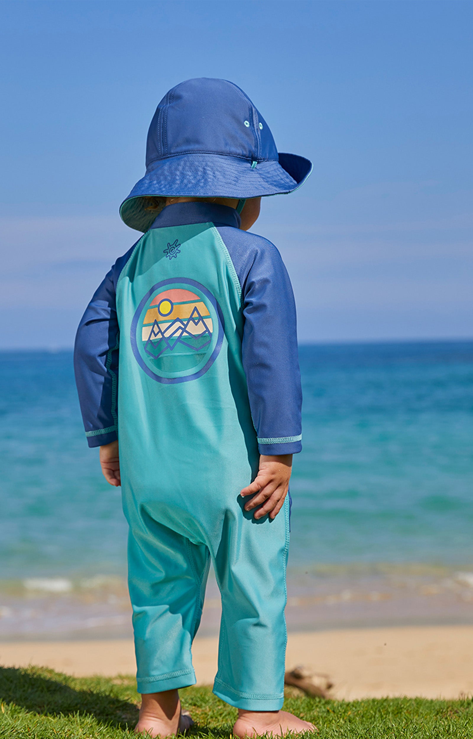 Baby boy on the beach in UV Skinz's baby boy's long-sleeve swimsuit in endless summer|endless-summer