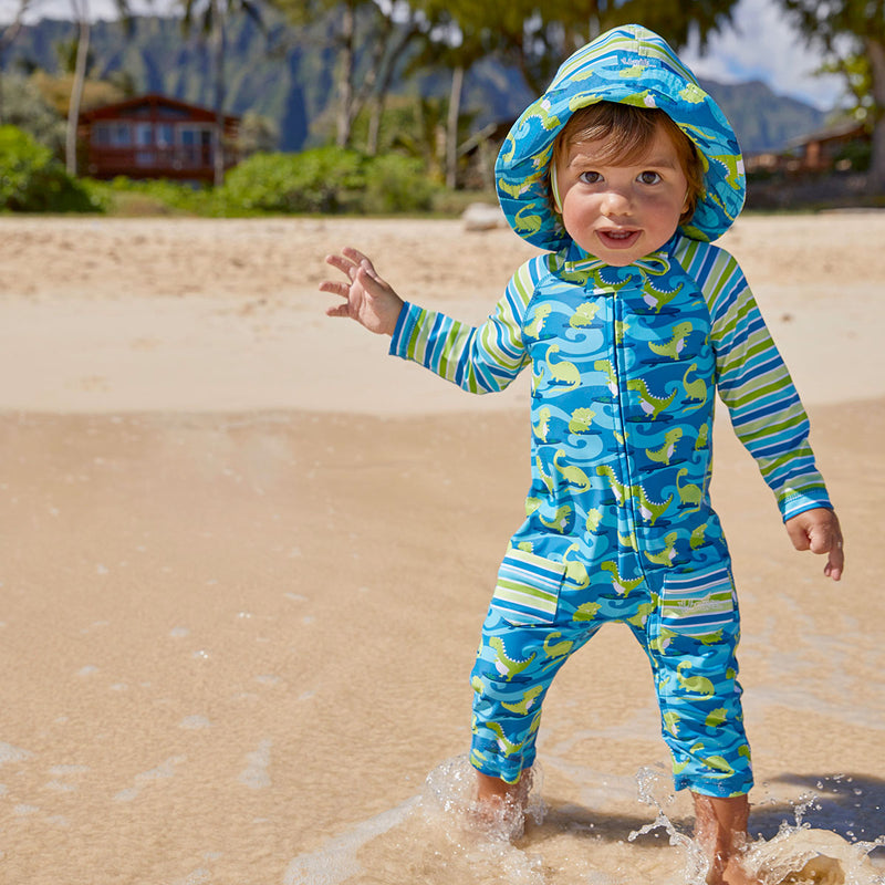 baby in UV Skinz's baby boy's long-sleeve swimsuit in surfing dinos|surfing-dinos
