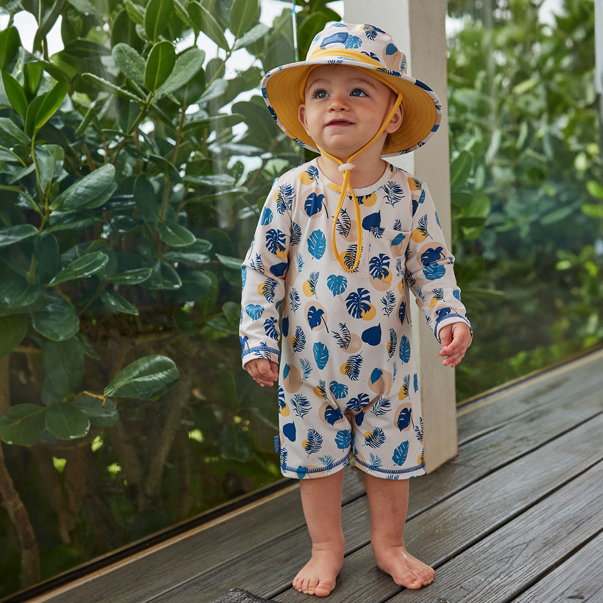 baby boy in uv sunzie on deck|shadow-leaf