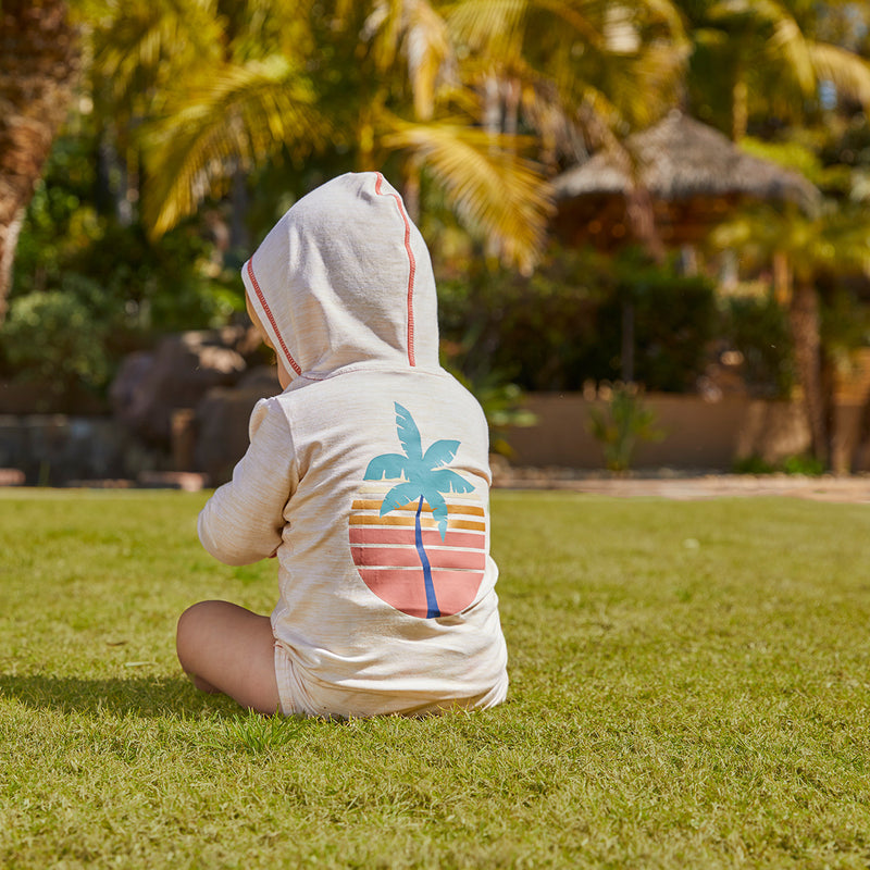 Baby in UV Skinz's onesie in sunset palm tree|sunset-palm-tree