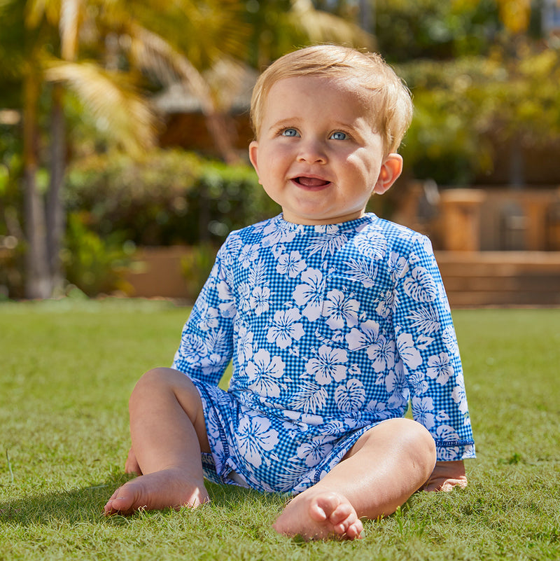 Little boy in UV Skinz's baby boy's UV onesie in blue hibiscus gingham|blue-hibiscus-gingham