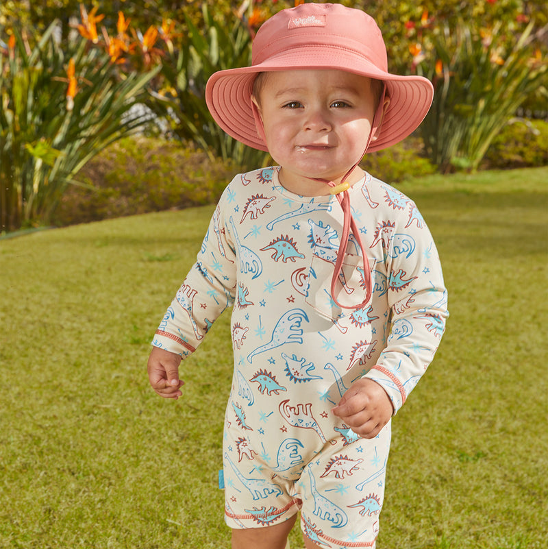 Baby boy in UV Skinz's baby boy's UV onesie in dino pals|dino-pals