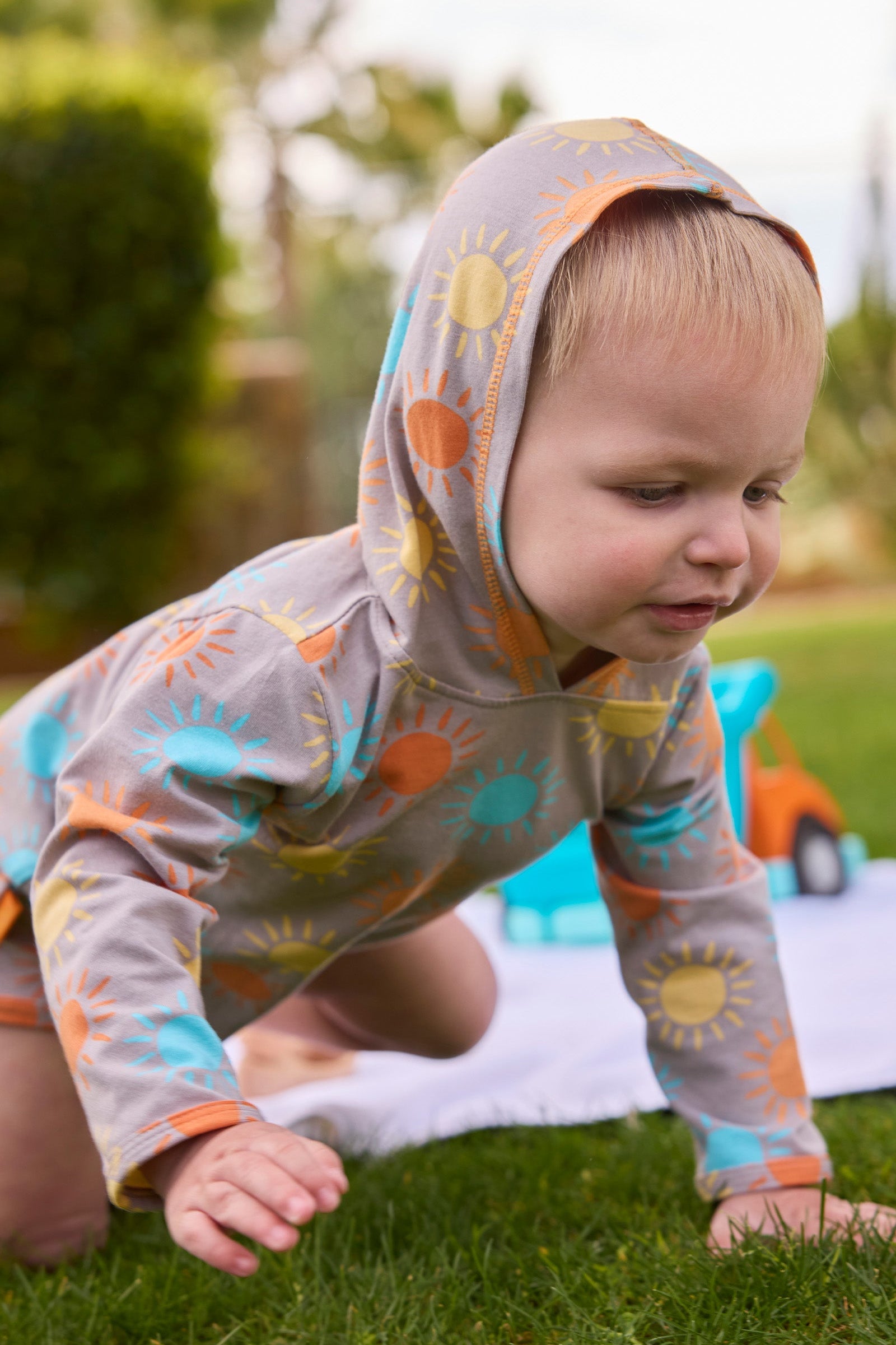 baby boy crawling in hooded sunzie