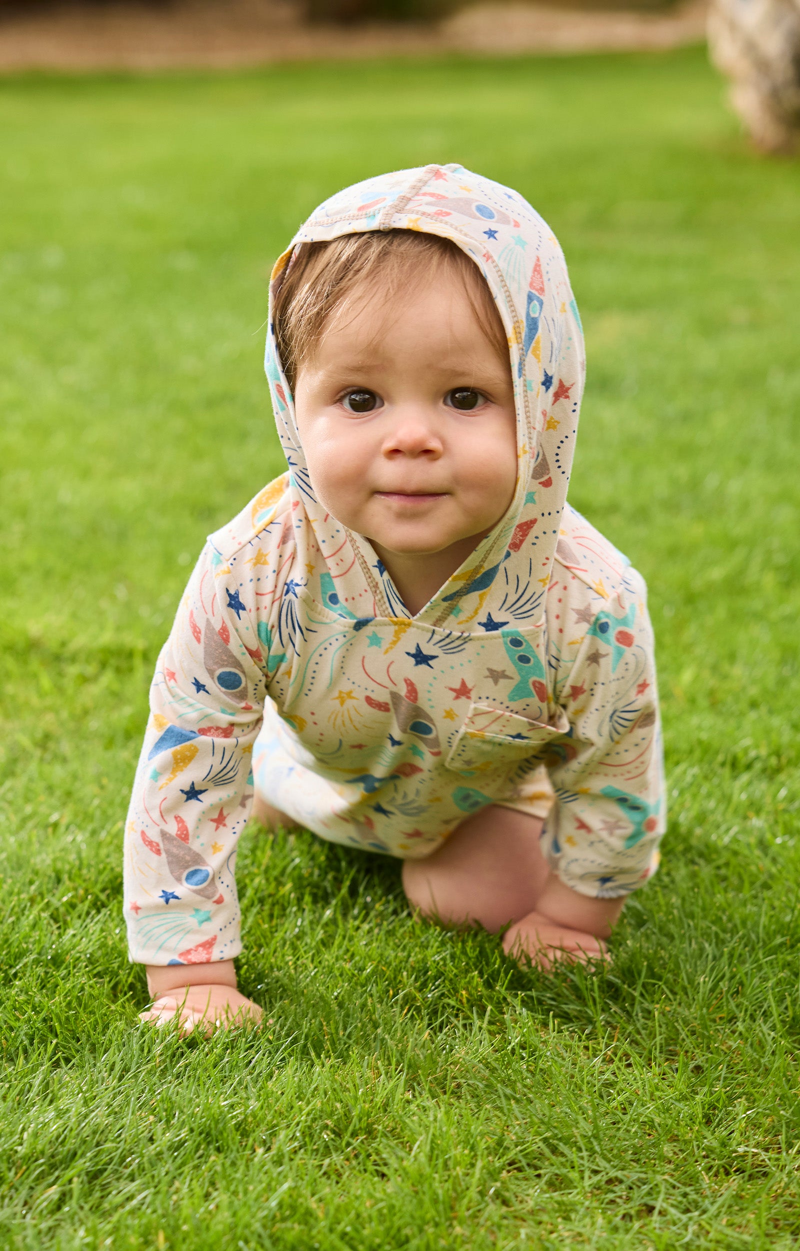 baby boy crawling in grass in hooded sunzie|rocket-jam
