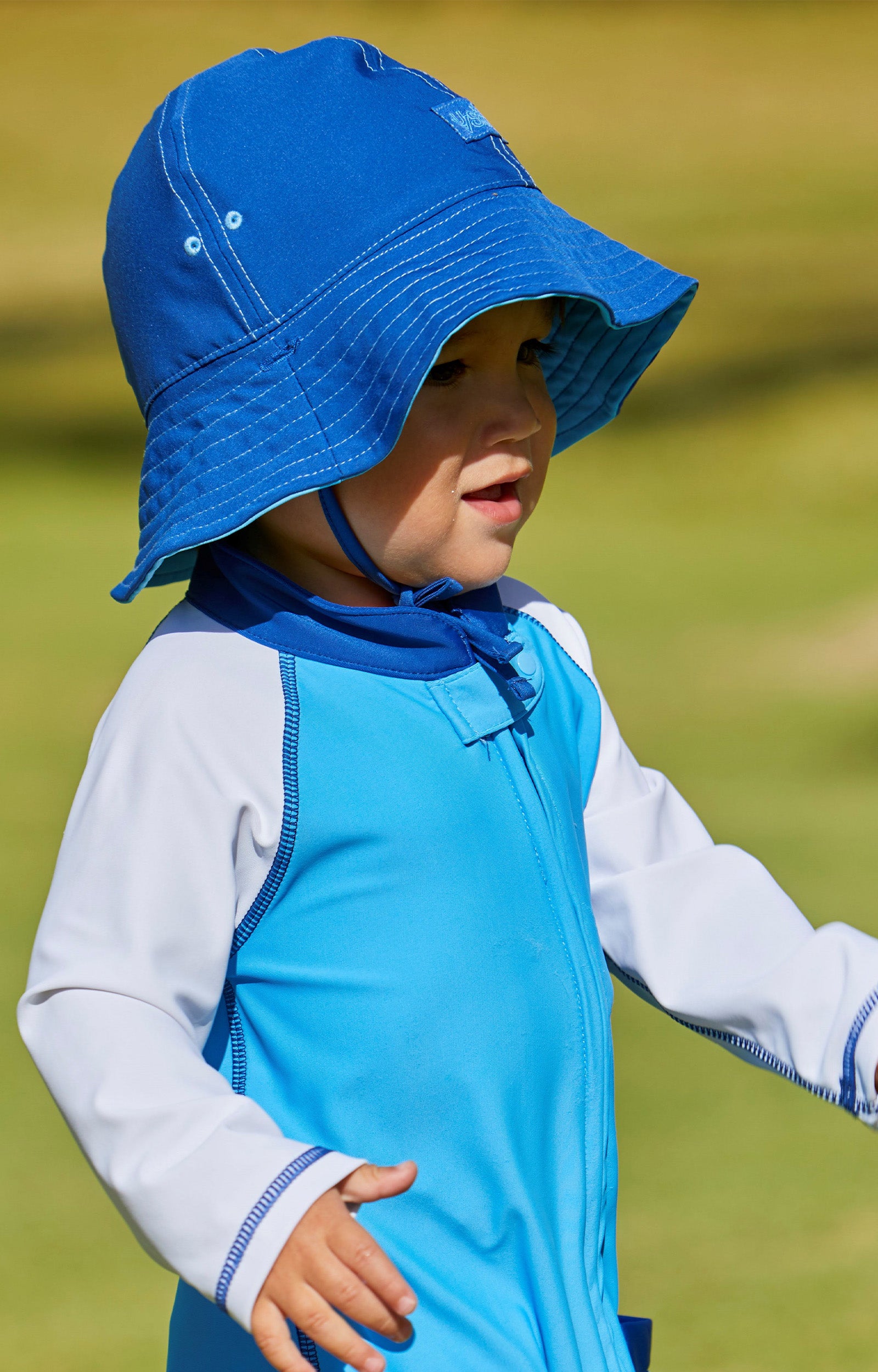 Little boy in UV Skinz's baby boy's sun hat in ocean blue navy|ocean-blue-navy