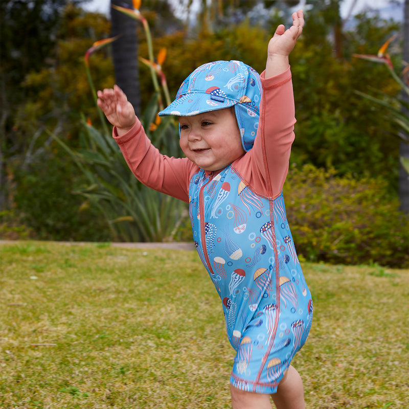 Little boy in UV Skinz's baby boy's swim flap hat|birdie-stripe