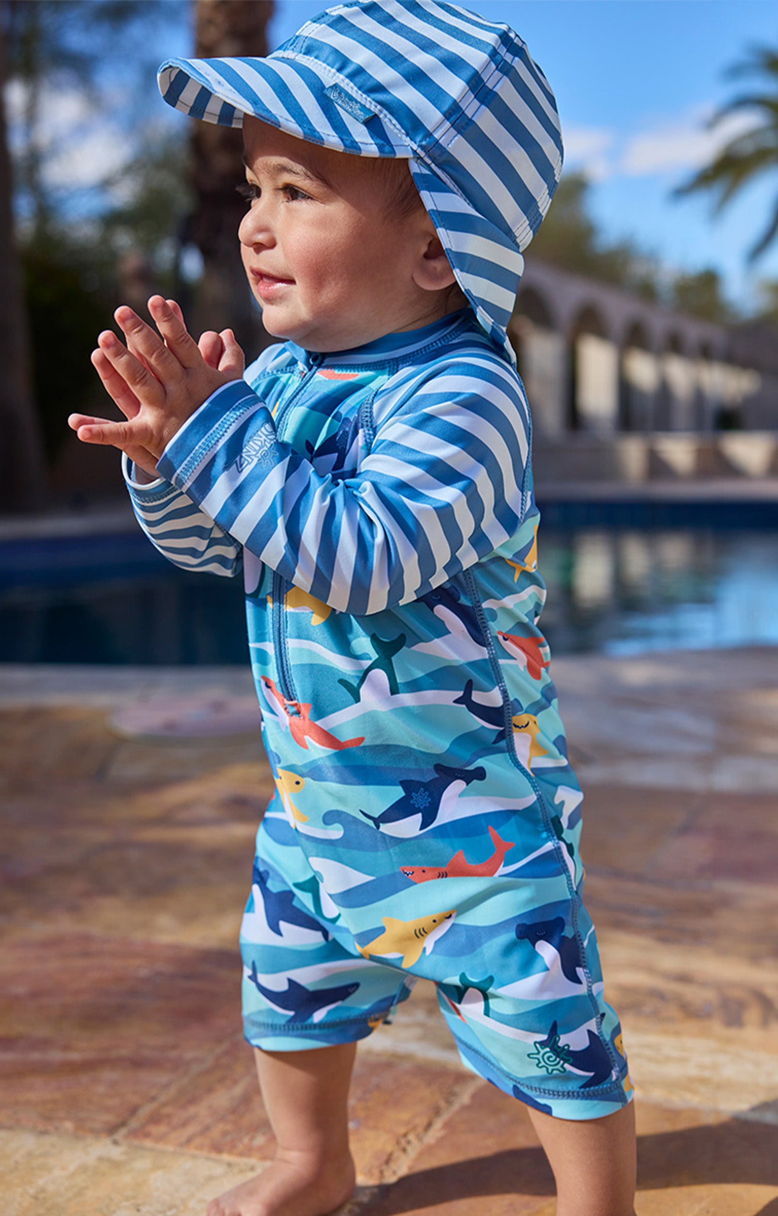 baby boy clapping by pool in swim flap hat|waverider-stripe