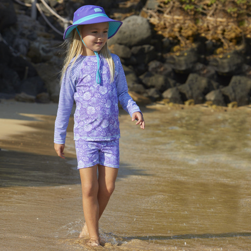 girl in UV Skinz's girl's swim shorts in dreamy shells|dreamy-shells